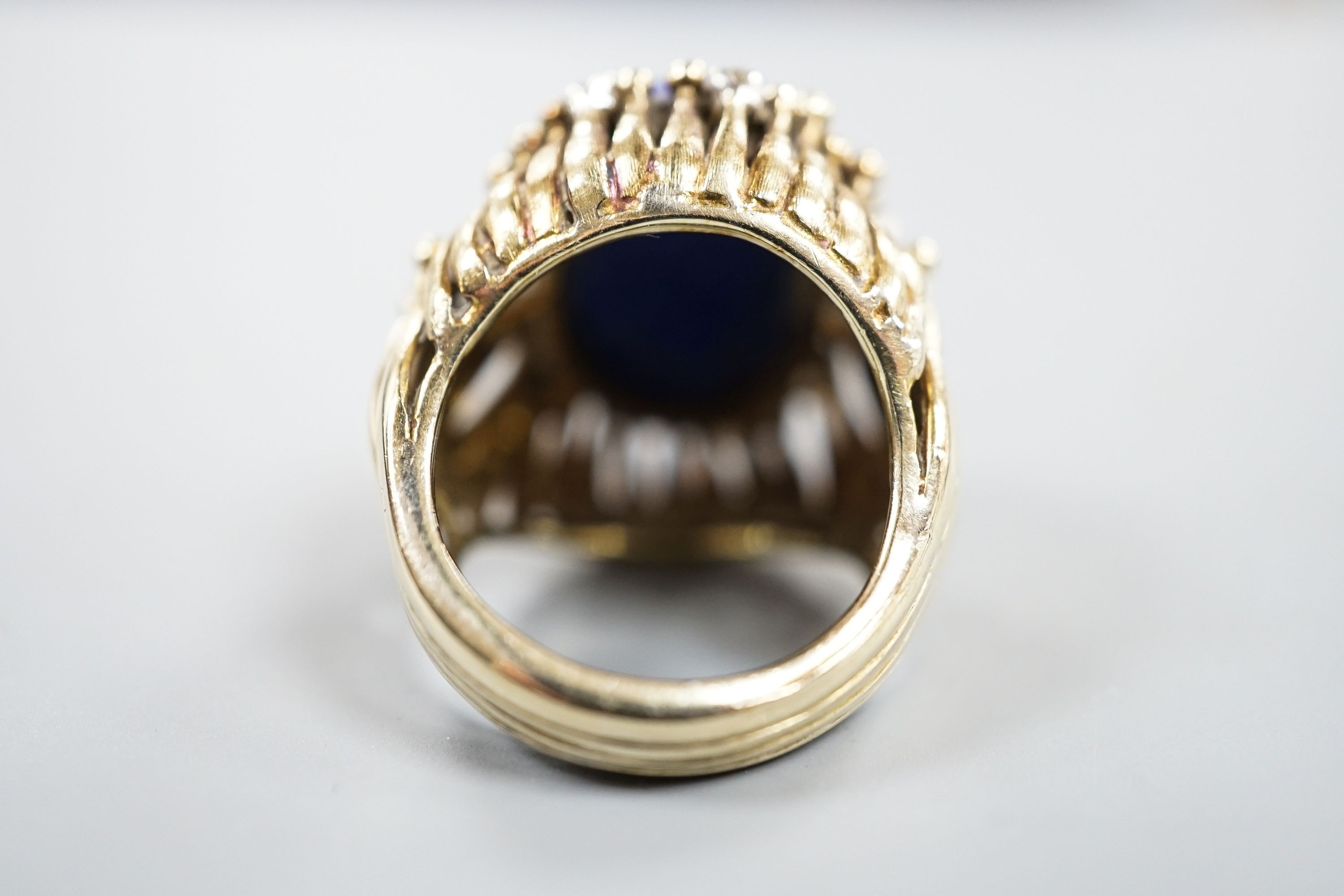 A pierced fluted 14k yellow metal, lapis lazuli and diamond set modernist dress ring, size K/L, gross weight 15.3 grams.